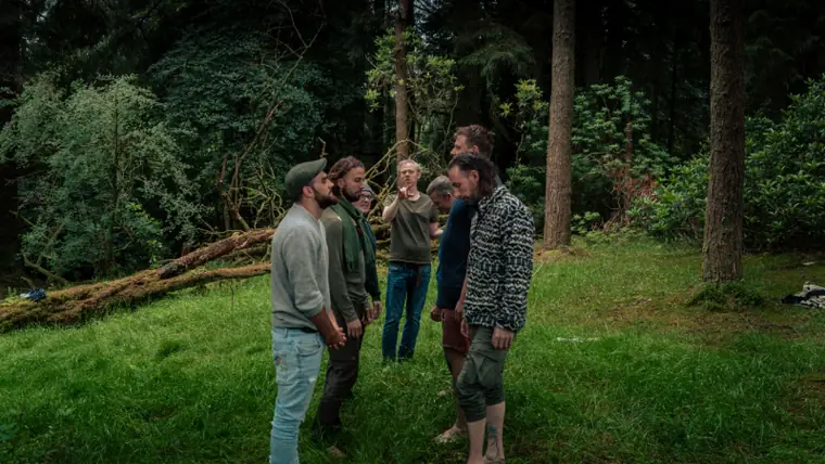 Men gathered in the woods